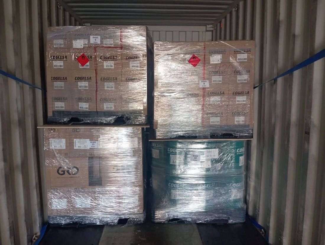 Palletised COGELSA pails and drums strapped in a shipping container — BHMS Dubai delivery