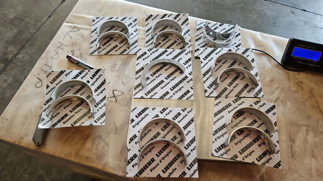 Genuine Liebherr crankshaft bearing shells on Liebherr Genuine Parts wrapping paper